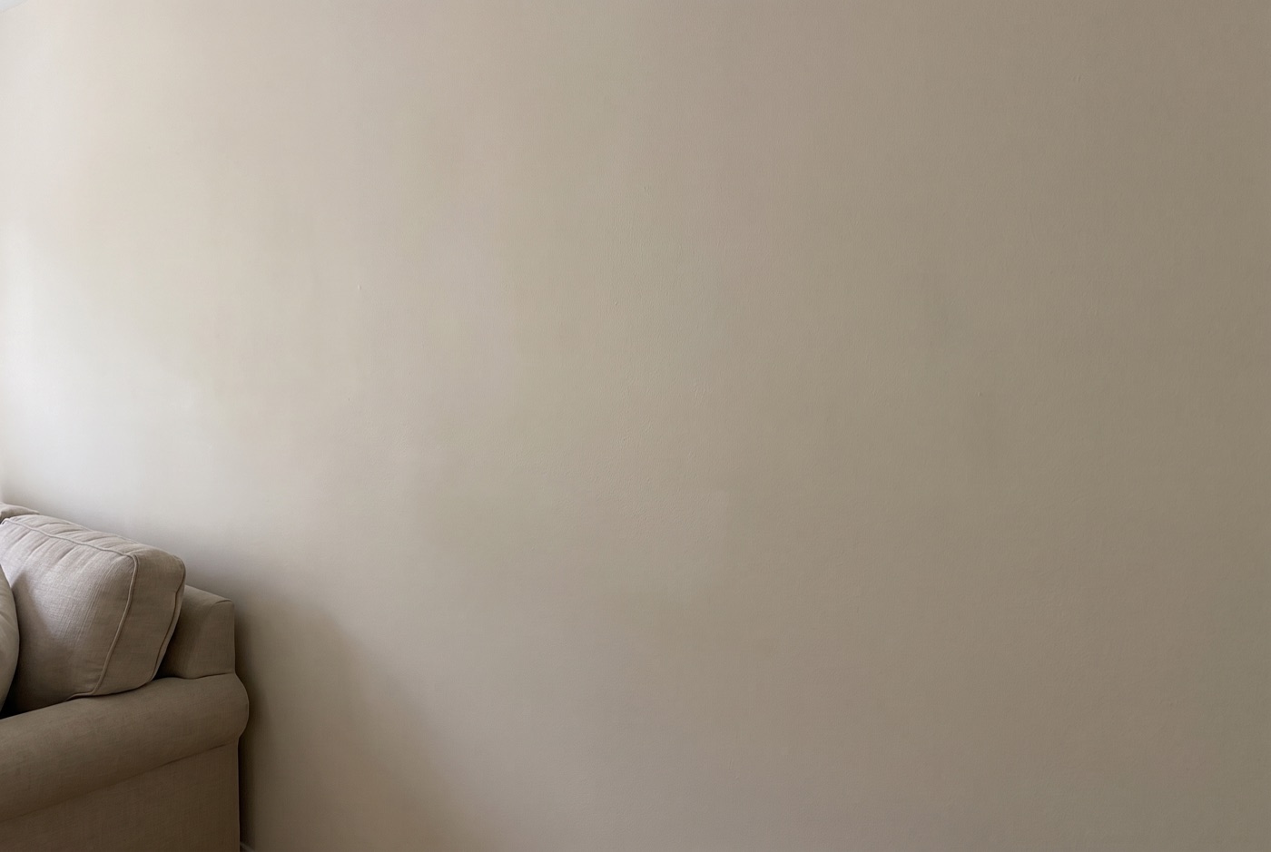 The same room shot square-on to a blank wall, flat and shallow